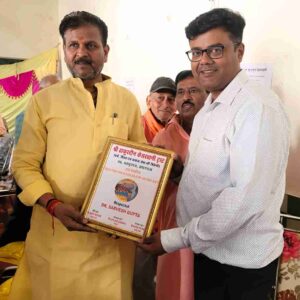 "Dr. Sarvesh Gupta receiving award and certificate from Hon’ble Mayor of Prayagraj during free medical camp organized by Thakurdin Kesarwani Trust"